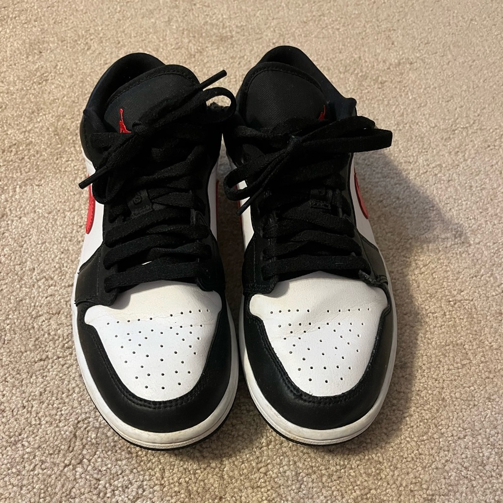 black and white jordan’s with red swoosh